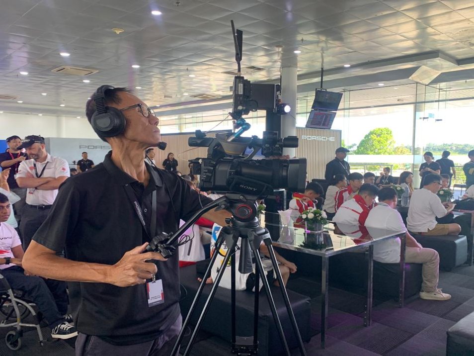 Vertex camera operator filming on-site at a Porsche event